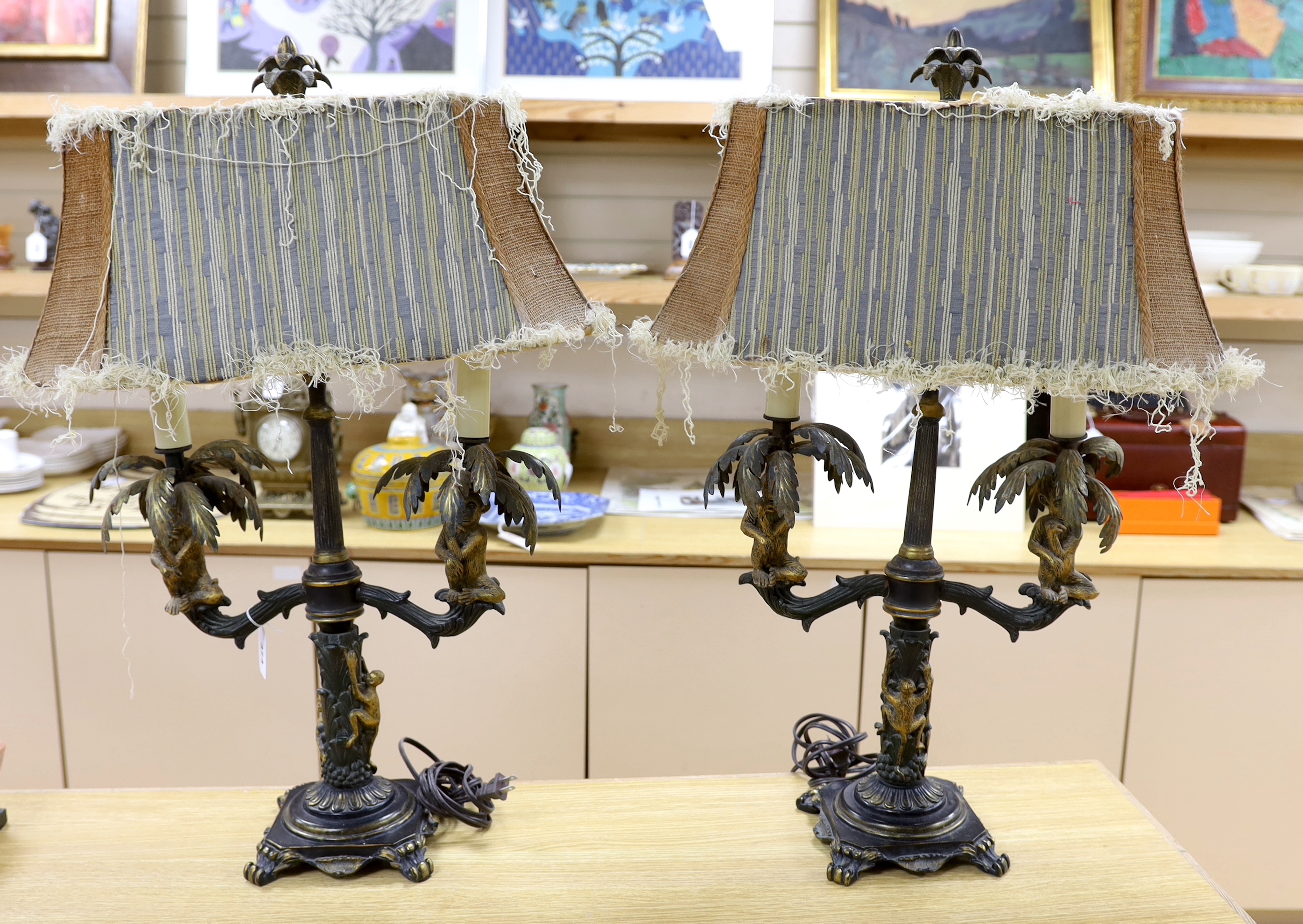 A pair of ornate brass sangerie lamps with shades, 78cm high